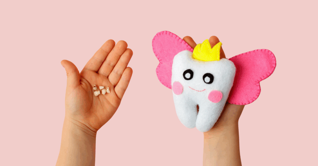 Felt tooth fairy pillow and milk tooth in kids hands on pink background.