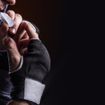 Boxer putting in a mouthguard for teeth protection.