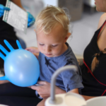 Toddler visits the dentist with his mom and dad.