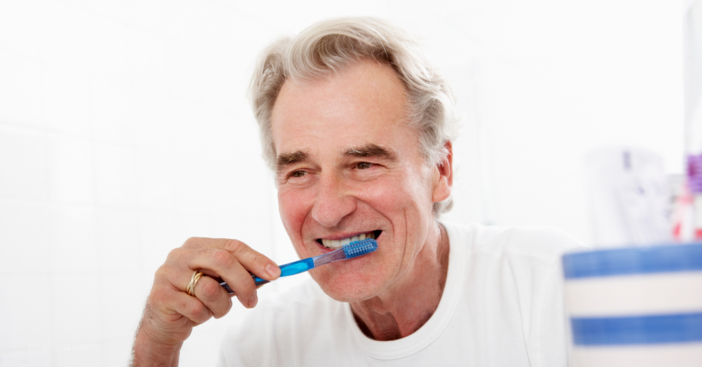 older man brushing his teeth with a blue toothbrush