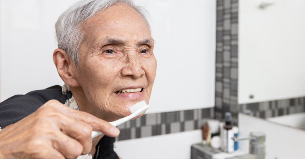 Happy healthy elderly person brushing their teeth.