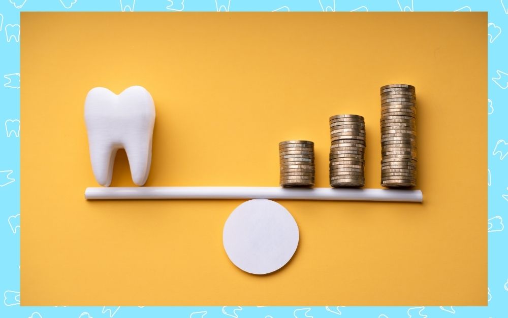 model scale with a tooth on one end and coins stacked on the other to balance